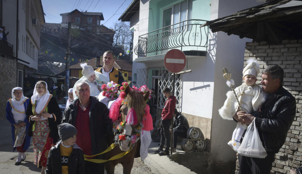 Families prepare to take part in a mass circumcision ceremony in the village of Ribnovo, Bulgaria, Sunday, April 11, 2021. Despite the dangers associated with COVID-19 and government calls to avoid large gatherings, Hundreds of people flocked to the tiny village of Ribnovo in southwestern Bulgaria for a four-day festival of feasting, music and the ritual of circumcision which is considered by Muslims a religious duty and essential part of a man's identity. (AP Photo/Jordan Simeonov)