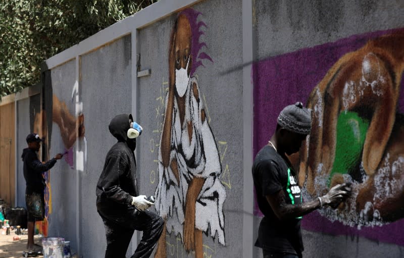 Graffiti artists from RBS crew work on their mural to encourage people to protect themselves amid the outbreak of the coronavirus disease (COVID-19), in Dakar