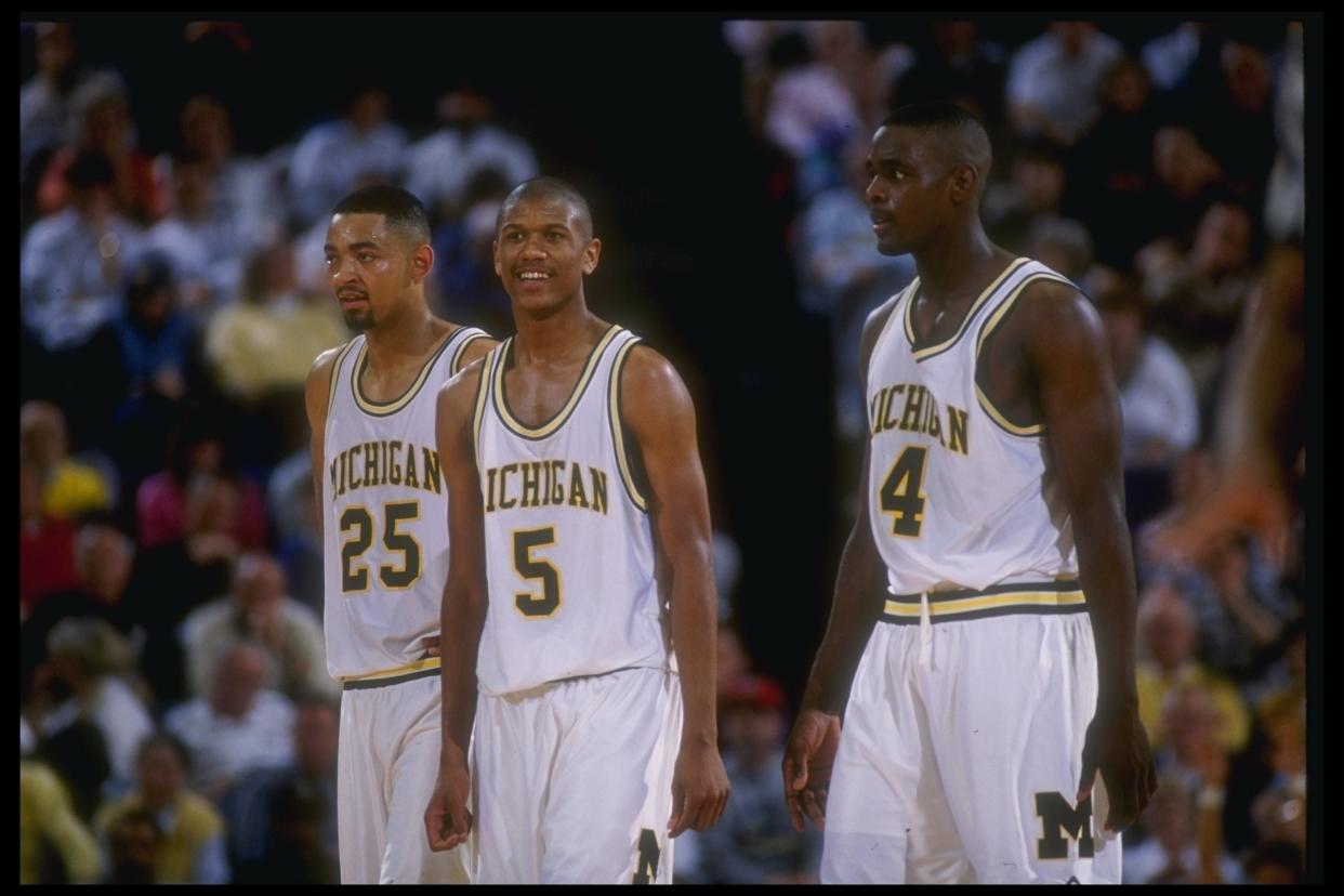 Michigan Wolverines forward Juwan Howard, guard Jalen Rose, and forward Chris Webber