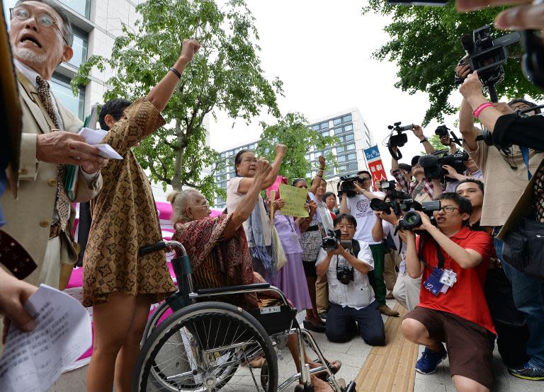 Supporters of former "comfort women" stage a standing demonstration near the Diet, or parliament, in Tokyo on June 2, 2014 to demand that Japan formally atone for forcing women into sexual slavery in its wartime military brothels