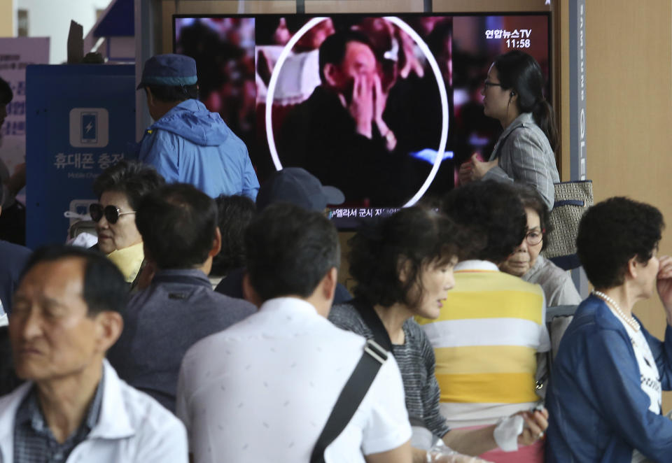 People watch a TV screen showing an image of senior North Korean official Kim Yong Chol in a musical performance by the wives of Korean People's Army officers in North Korea during a news program at the Seoul Railway Station in Seoul, South Korea, Monday, June 3, 2019. A senior North Korean official who had been reported as purged over the failed nuclear summit with Washington was shown in state media on Monday enjoying a concert alongside leader Kim Jong Un. (AP Photo/Ahn Young-joon)