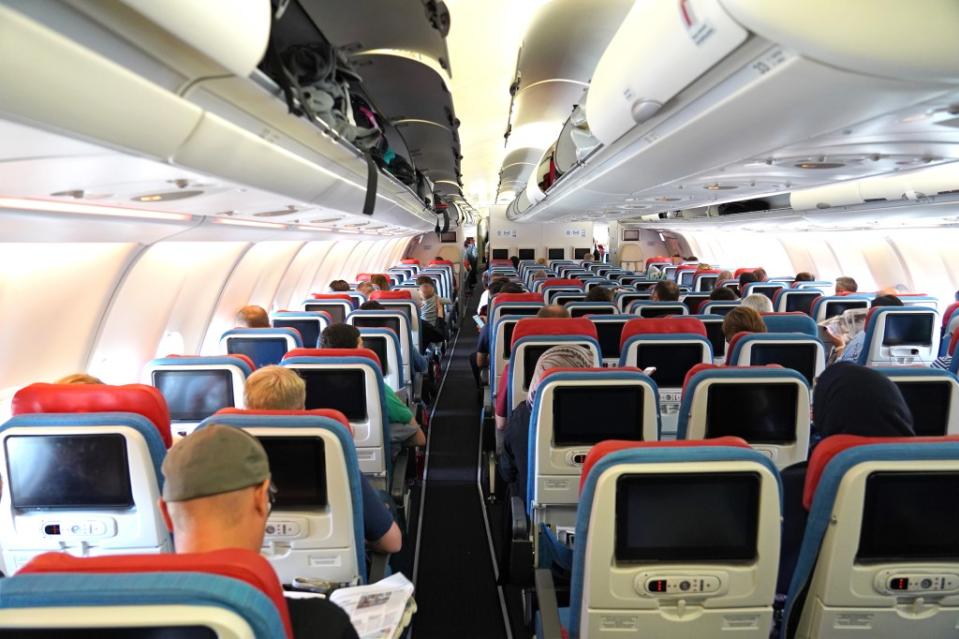 Flying in the middle seat can be brutal. Some experts say the only reward is having access to both armrests. Others disagree. Hayati Kayhan – stock.adobe.com