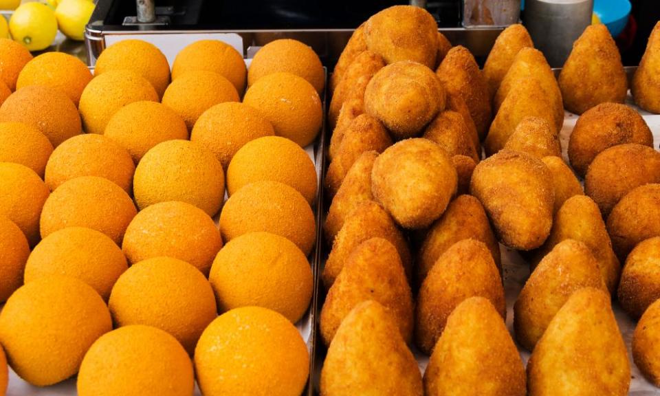 Round and conical arancini; the latter are inspired by the shape of Mount Etna.