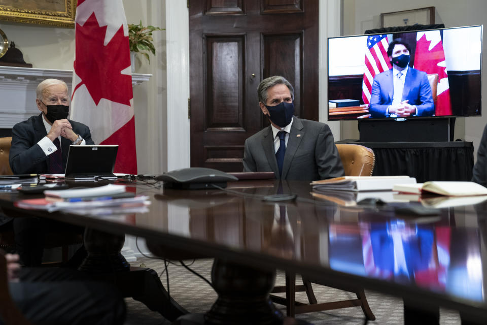 President Joe Biden and Secretary of State Antony Blinken listen as Canadian Prime Minister Justin Trudeau speaks during a virtual bilateral meeting, in the Roosevelt Room of the White House, Tuesday, Feb. 23, 2021, in Washington. (AP Photo/Evan Vucci)