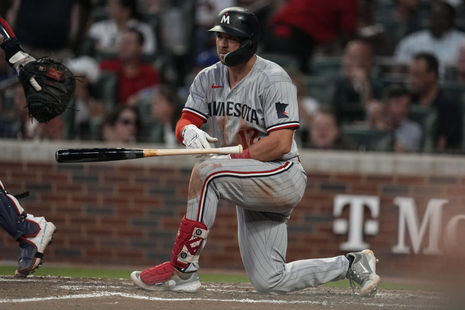 Minnesota Twins' Kyle Farmer (12) tosses his bat after striking out to end the team's half of the seventh inning of a baseball game against the Atlanta Braves, Monday, June 26, 2023, in Atlanta. (AP Photo/John Bazemore)