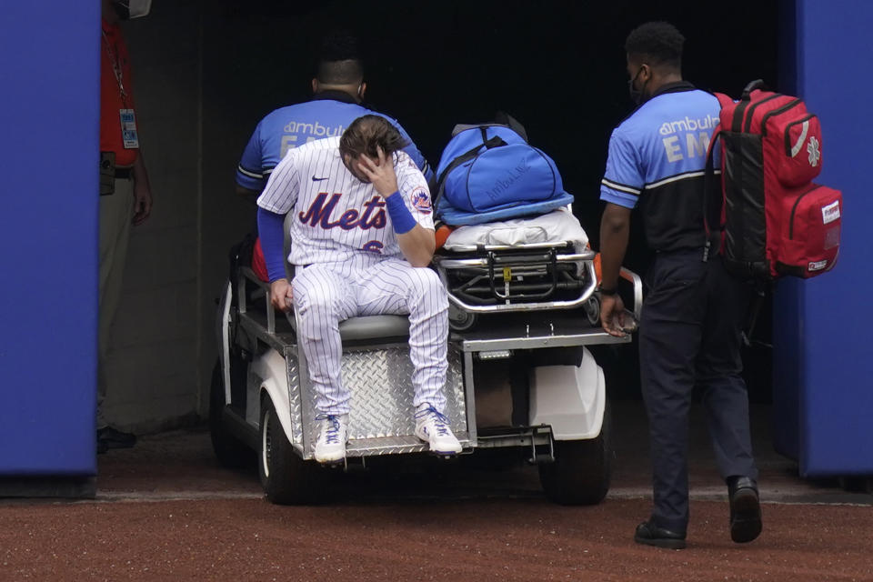 New York Mets left fielder Jeff McNeil reacts as he rides a cart off the field after being injured during the first inning of a baseball game against the Washington Nationals at Citi Field, Thursday, Aug. 13, 2020, in New York. (AP Photo/Seth Wenig)