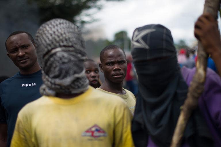 Protesters stand at a barricade in the Musaga neighbourhood of Bujumbura, Burundi, on May 5, 2015