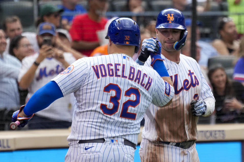 New York Mets' Pete Alonso celebrates with Daniel Vogelbach (32) after hitting a solo home run during the seventh inning of a baseball game against the Pittsburgh Pirates, Wednesday, Aug. 16, 2023, in New York. (AP Photo/Mary Altaffer)