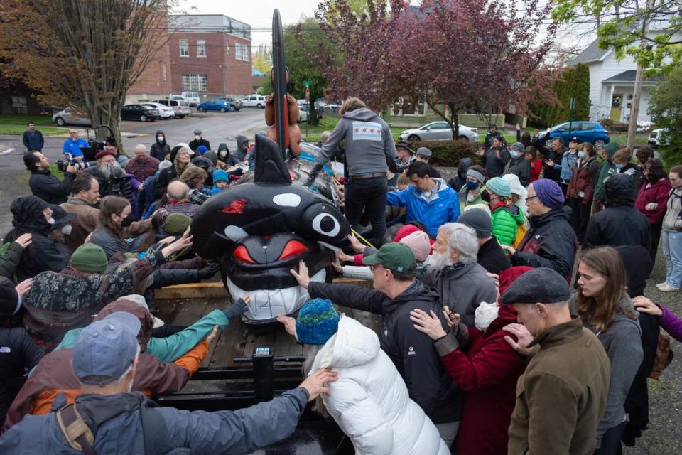 Bellingham community members gather to bless the House of Tears Carvers totem pole made for The Snake River to Salish Sea Spirit of the Waters totem pole journey at its launch Tuesday, May 3, 2022, at Bellingham Unitarian Fellowship in Bellingham, Wash. The 2,300-mile journey highlights the vital role of the Snake River, salmon and orca to the lifeways and identities of Tribal communities in the region.