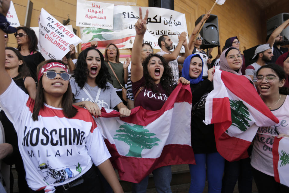 Anti-government protesters shout slogans against the Lebanese government in Beirut, Lebanon, Tuesday, Oct. 22, 2019. Prime Minister Saad Hariri briefed western and Arab ambassadors Tuesday of a reform plan approved by the Cabinet that Lebanon hopes would increase foreign investments to help its struggling economy amid wide skepticism by the public who continued in their protests for the sixth day. (AP Photo/Hassan Ammar)