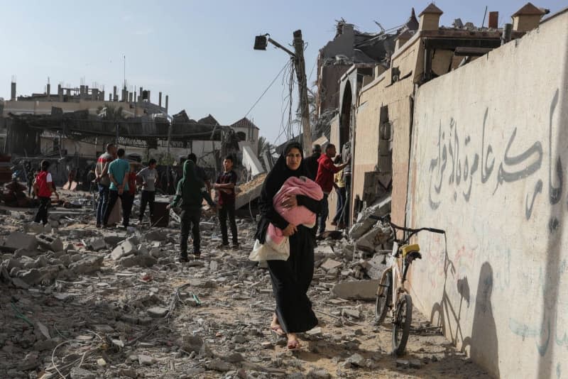 Palestinians inspect damaged houses after Israeli warplanes bombed a home for the Al-Shaer family, leading to widespread destruction in the Al-Salam neighbourhood, east of the city of Rafah, in the southern Gaza Strip. Abed Rahim Khatib/dpa