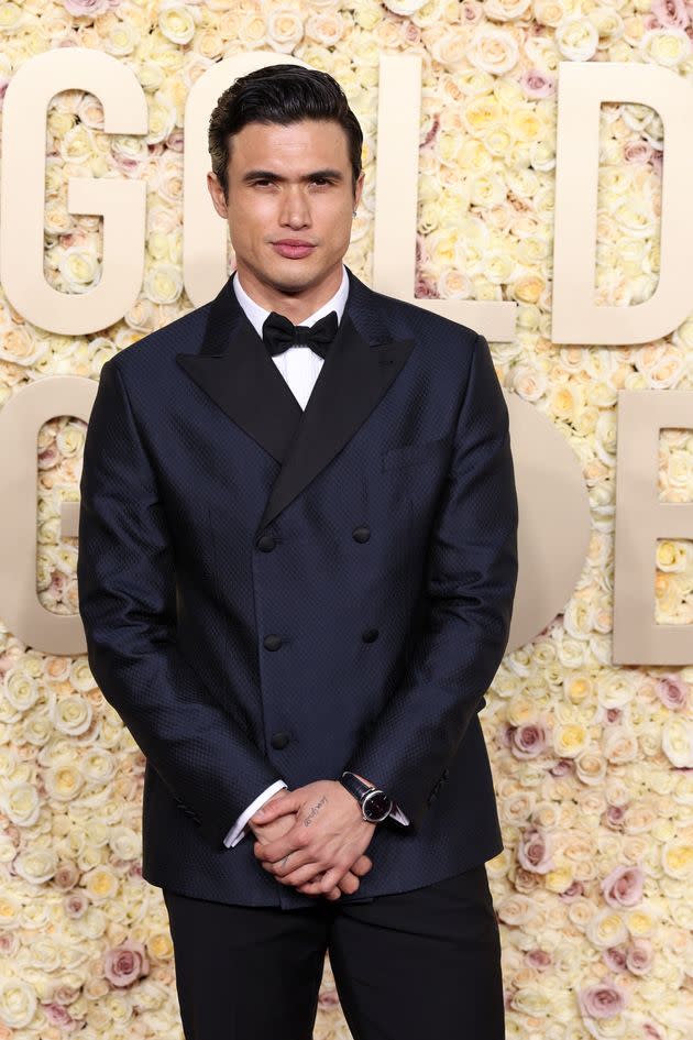 Charles Melton stuck to the classics with a navy blue double-breasted jacket, white button down shirt and bowtie.