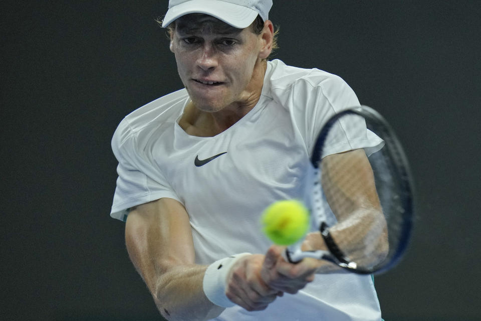 Jannik Sinner of Italy hits a return shot against Carlos Alcaraz of Spain during the men's singles semifinal match in the China Open tennis tournament at the Diamond Court in Beijing, Tuesday, Oct. 3, 2023. (AP Photo/Andy Wong)