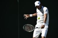 Feliciano Lopez of Spain hits a shot during his match against Steve Darcis of Belgium at the Wimbledon Tennis Championships in London, June 30, 2015. REUTERS/Toby Melville