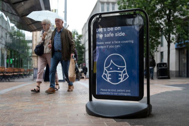 Shoppers pass a sign encouraging people to wear masks to reduce the transmission of the coronavirus outside of a Tesco supermarket. The U.K. has the second highest number of COVID-19 cases, according to the WHO. (Photo: Daniel Harvey Gonzalez via Getty Images)