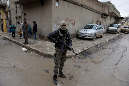 A member of Turkey-backed Free Syrian Army police forces patrol in Azaz, Syria January 26, 2018. REUTERS/Umit Bektas