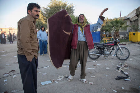 A man reacts following an earthquake in Sarpol-e Zahab county in Kermanshah, Iran. REUTERS/Tasnim News Agency