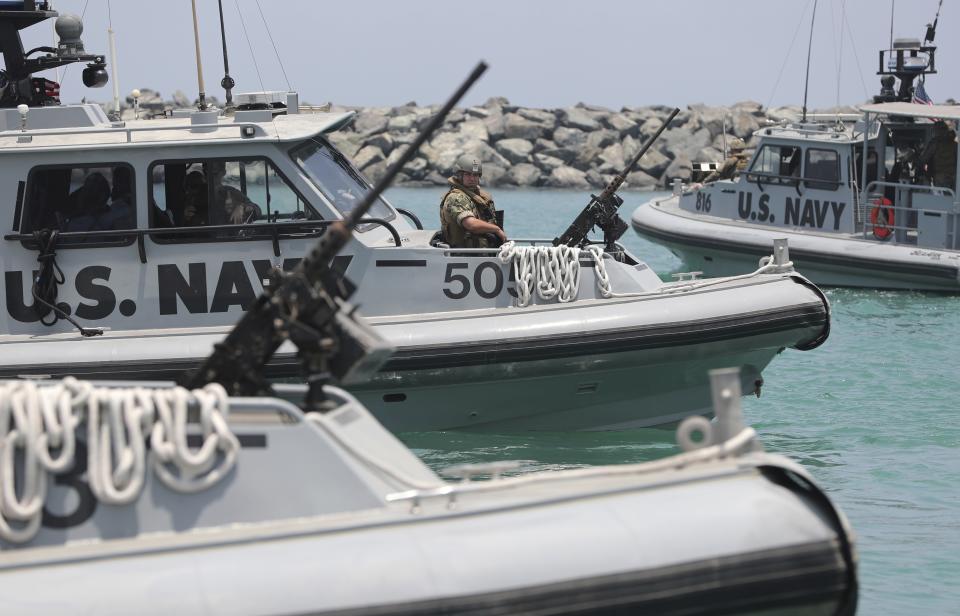 U.S. Navy patrol boats carrying journalists to see damaged oil tankers leaves a U.S. Navy 5th Fleet base near Fujairah, United Arab Emirates, Wednesday, June 19, 2019. The limpet mines used to attack a Japanese-owned oil tanker near the Strait of Hormuz bore "a striking resemblance" to similar mines displayed by Iran, a U.S. Navy explosives expert said Wednesday. Iran has denied being involved. (AP Photo/Kamran Jebreili)