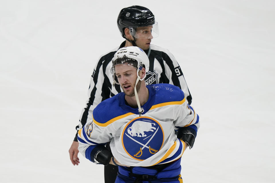 Buffalo Sabres' Colin Miller is escorted to the penalty box after fighting with New York Islanders' Anders Lee during the third period of an NHL hockey game Thursday, March 4, 2021, in Uniondale, N.Y. The Islanders won 5-2. (AP Photo/Frank Franklin II)