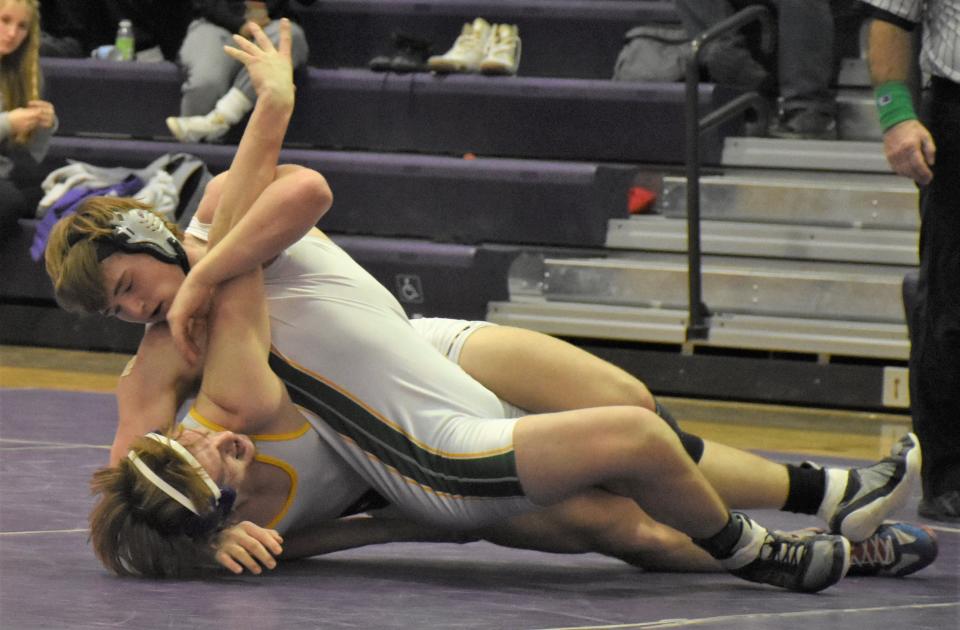 Adirondack Wildcat Isaac Croneiser (top) competes with Holland Patent Golden Knight Nick DeForrest in the 215-pound title match Saturday at Section III's Class C tournament.