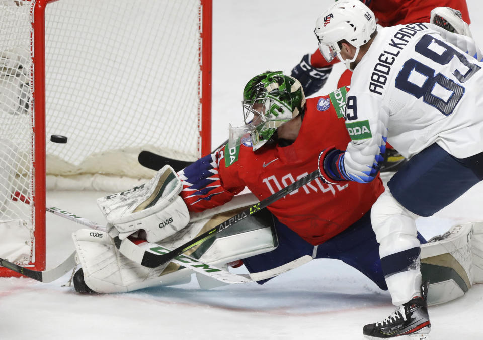 Norway's goaltender Henrik Haukeland fails to stop a goal by Conor Garland of the US during the Ice Hockey World Championship group B match between Norway and United States at the Arena in Riga, Latvia, Saturday, May 29, 2021. (AP Photo/Sergei Grits)