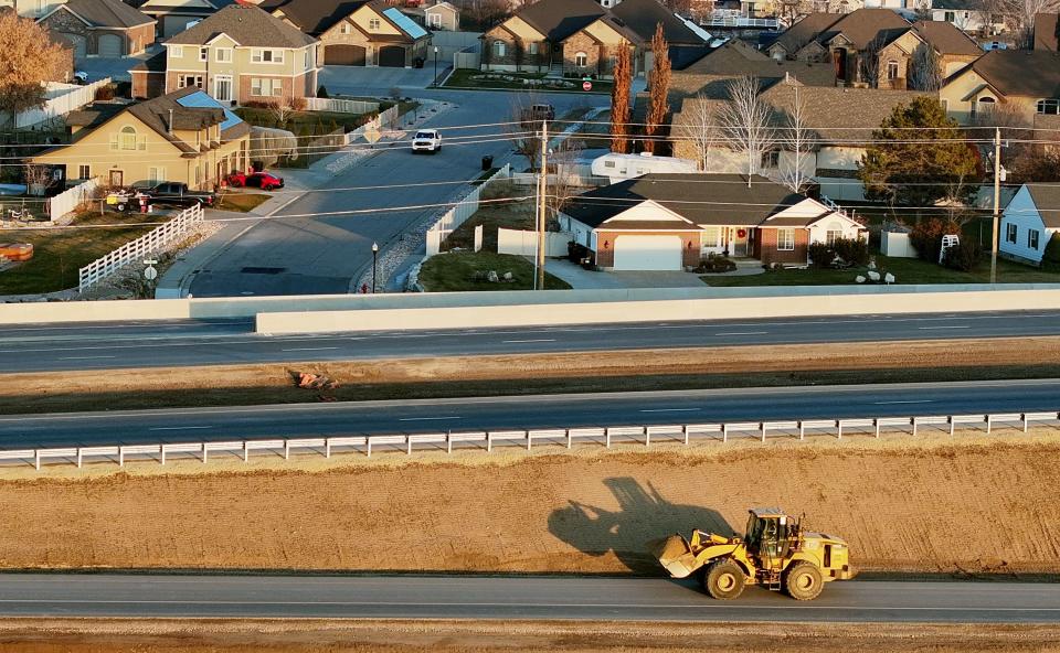 A worker drives a loader with a load of dirt in Syracuse as they work on the West Davis Corridor, which connects western Davis County communities with a viable alternative to I-15, on Tuesday, Jan. 2, 2024. | Scott G Winterton, Deseret News