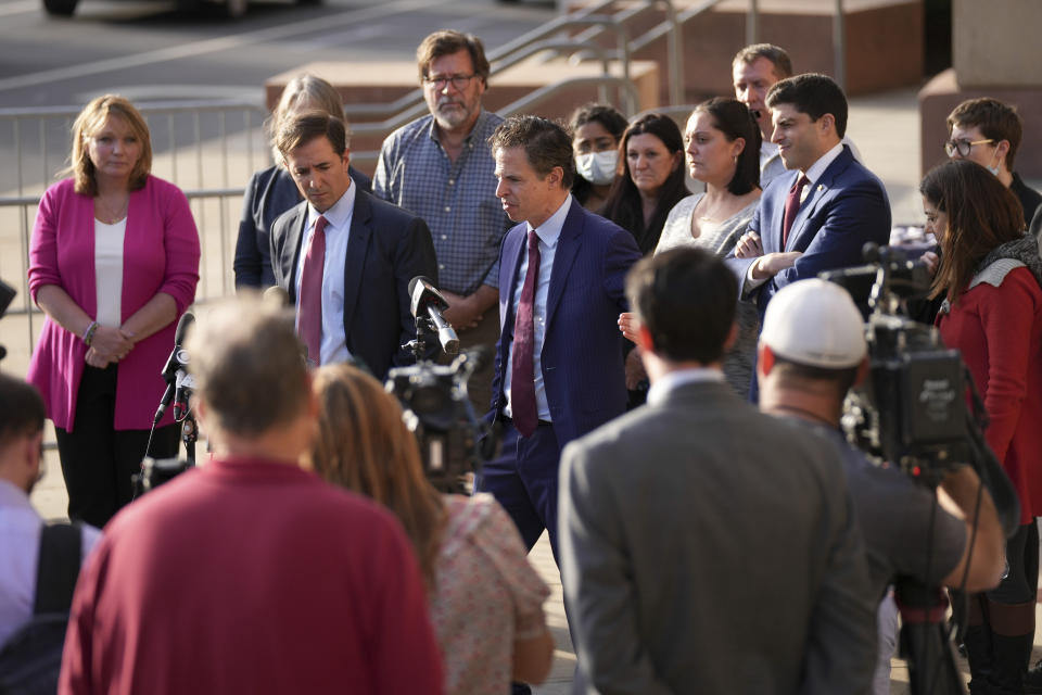 The lawyers representing the families of the victims of the shooting at Sandy Hook Elementary speak to the media after jurors returned a $965 million dollar judgement in the defamation trial against Alex Jones, in Waterbury, Conn, Wednesday, Oct. 12, 2022. (AP Photo/Bryan Woolston)