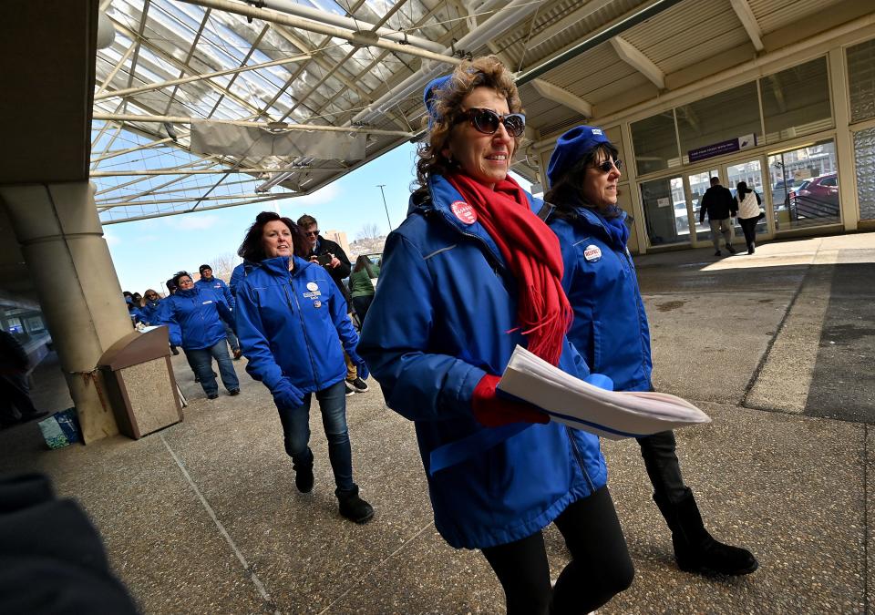 Marlena Pellegrino, left, and Dominique Muldoon, co-chairs of the Massachusetts Nurses Association, deliver a petition to the St. Vincent Hospital leadership in February. Muldoon is one of the eight plaintiffs in the lawsuit against St. Vincent.