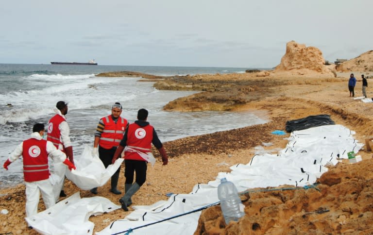 Libyan Red Crescent volunteers recovering the bodies of 74 migrants that washed ashore on February 20 near Zawiyah on Libya’s northern coast on February 21, 2017