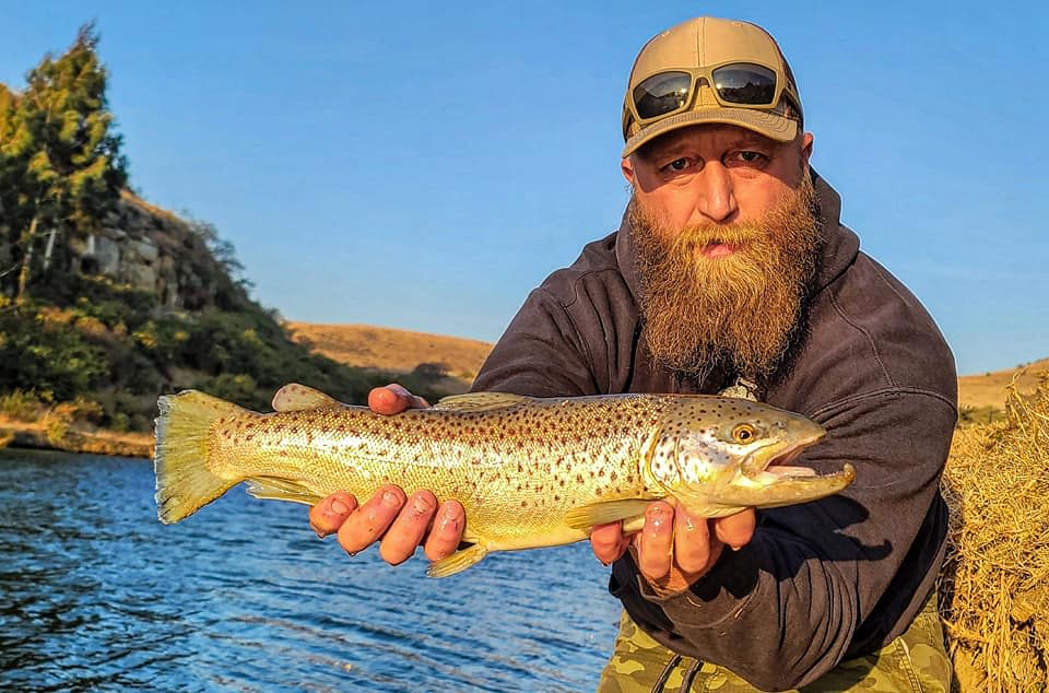 Ryan Baudhuin, a Wrightstown combat veteran who won the title of Most Benevolent Beard in America, poses with a fish he caught.