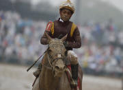 <p>Ricardo Santana Jr. is covered in mud after riding Whitmore in a race before the 144th running of the Kentucky Derby horse race at Churchill Downs Saturday, May 5, 2018, in Louisville, Ky. (Photo: John Minchillo/AP) </p>