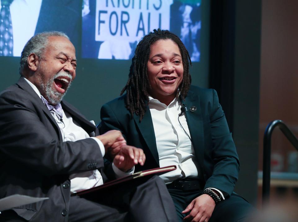 State Rep. Keturah Herron, right, laughs with state Sen. Gerald Neal during a discussion about of the 1964 March on Frankfort as part of the Frazier History Museum's Bridging the Divide Series in Louisville, Ky. on Feb. 22, 2024. The march featured speakers such as the Martin Luther King Jr. and Jackie Robinson.