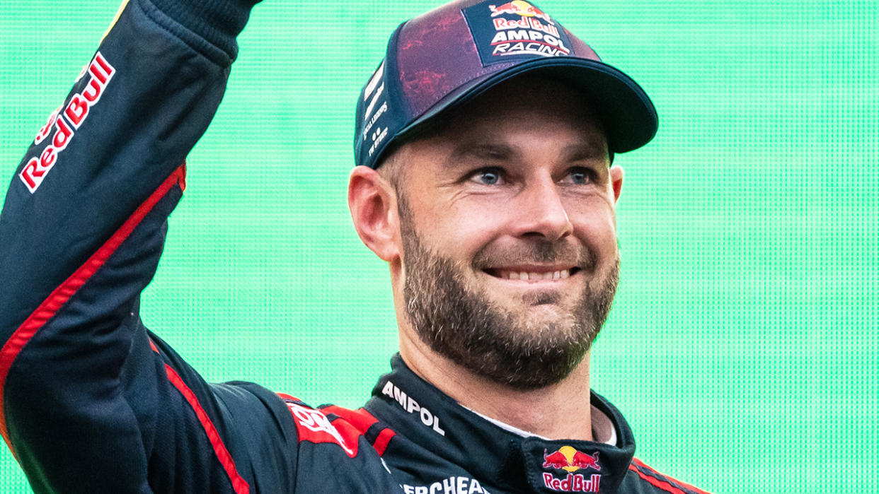 Shane van Gisbergen celebrates on the podium after a race win.