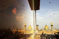 <b>KARBALA, IRAQ:</b> An Iraqi woman prays as Imam Abbas mosque is seen in the holy Shiite city of Karbala, south of Baghdad, Iraq. Karbala is famous as the site of the martyrdom of Hussein ibn Ali. The mosque, known to Shias as the Al-Abbas Mosque or Masjid al-Abbas, is the mausoleum of Al-Abbas ibn Ali, the martyr's loyal half-brother.