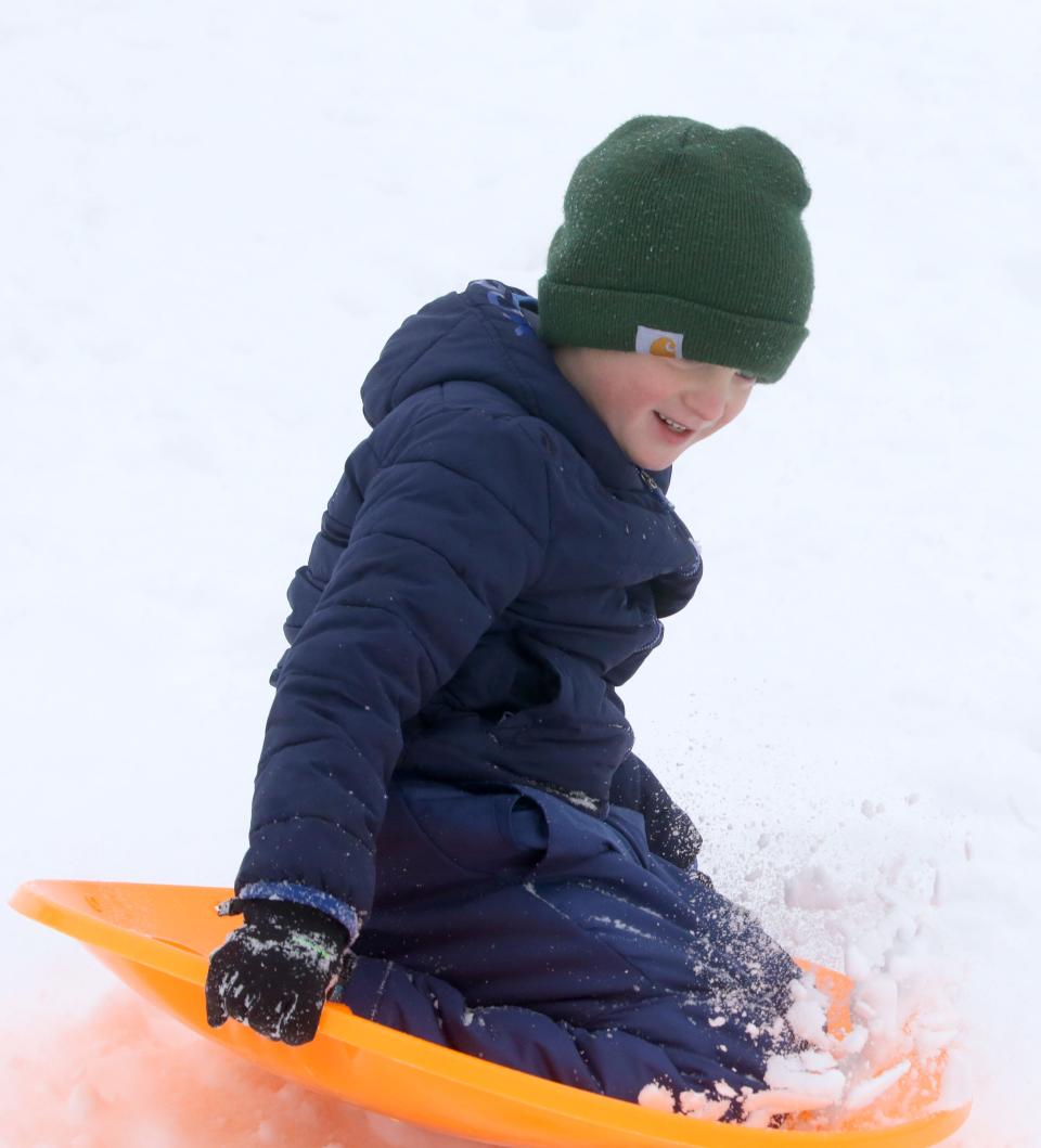 Samson Belk, 6, sleds down a hill Wednesday, Jan. 10, 2024 at Longfellow Elementary School in Iowa City, Iowa.