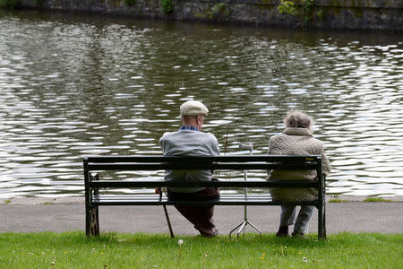 FILE PHOTO: Pensioners sit on a bench in a park in Merthyr Tydfil, Wales, May 22, 2017. REUTERS/Rebecca Naden/File Photo