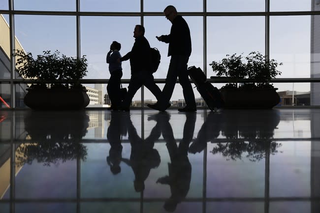 FILE - In this Feb. 14, 2013 file photo, Travelers pass through a corridor at Philadelphia International Airport in Philadelphia. As the Justice Department launches an investigation into possible collusion in the airline industry, experts say the government faces the burden of proving that the carriers were deliberately signaling business decisions to each other. (AP Photo/Matt Rourke, File)