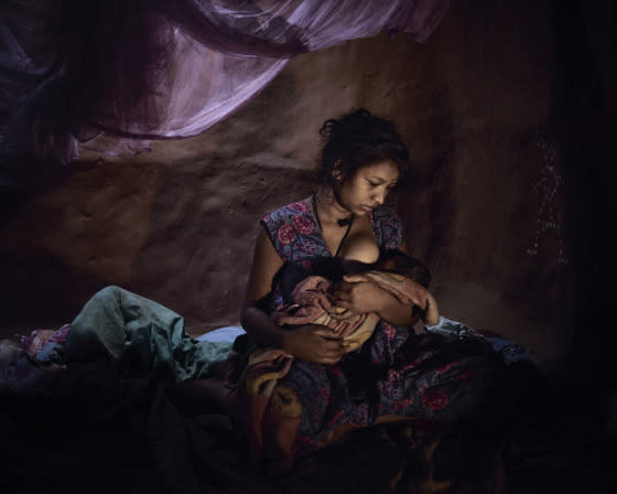 Saraswati, 16, must live in a closed dark room with her baby because she bled after childbirth.