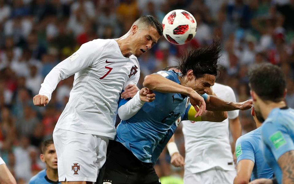Portugal's Cristiano Ronaldo (left) and Uruguay's Edinson Cavani challenge for a header during the 2018 World Cup. The teams will meet again in the first round this year.