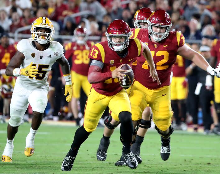 USC quarterback Caleb Williams scrambles with the ball through the Arizona State defense