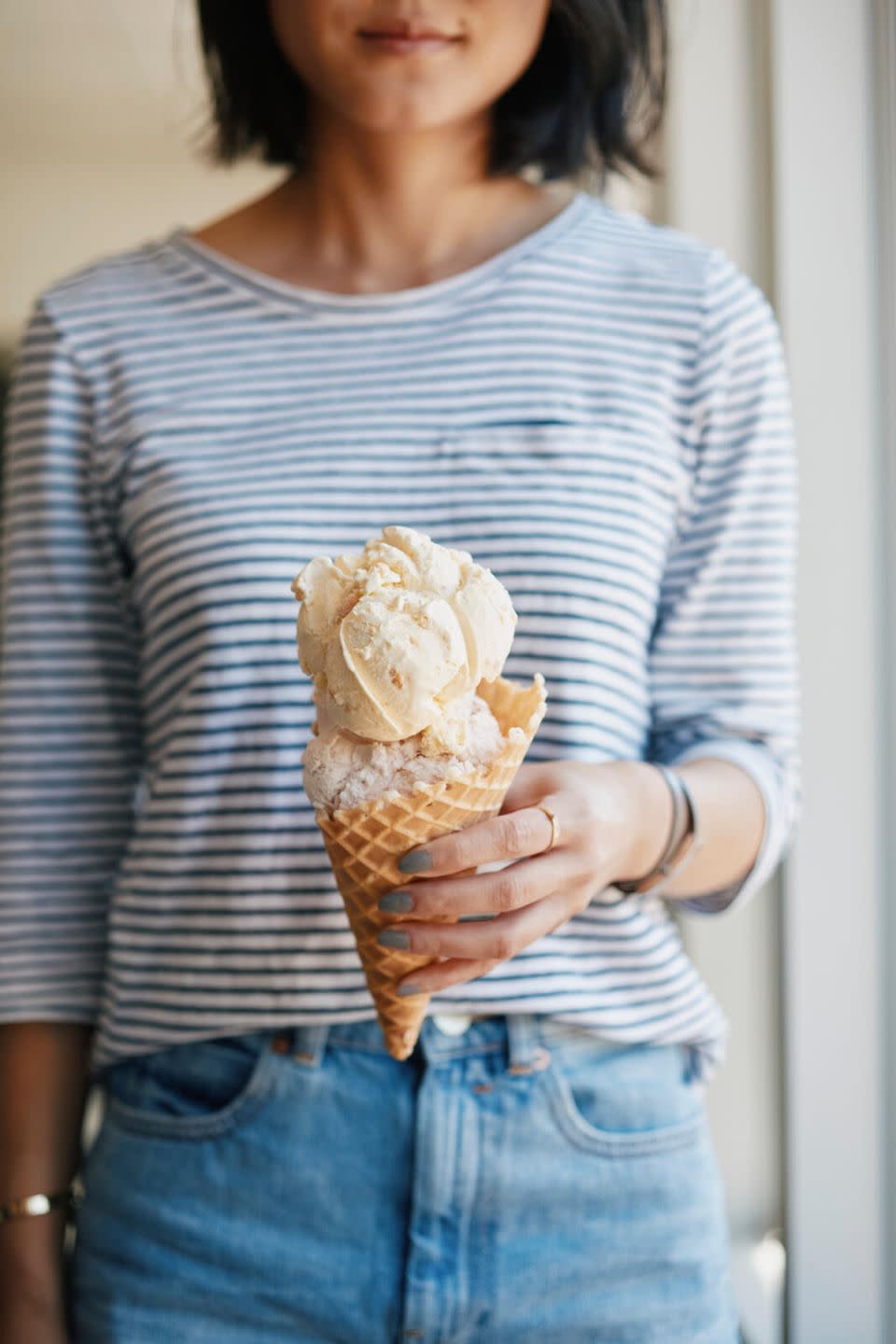 a woman holding a bag of ice cream