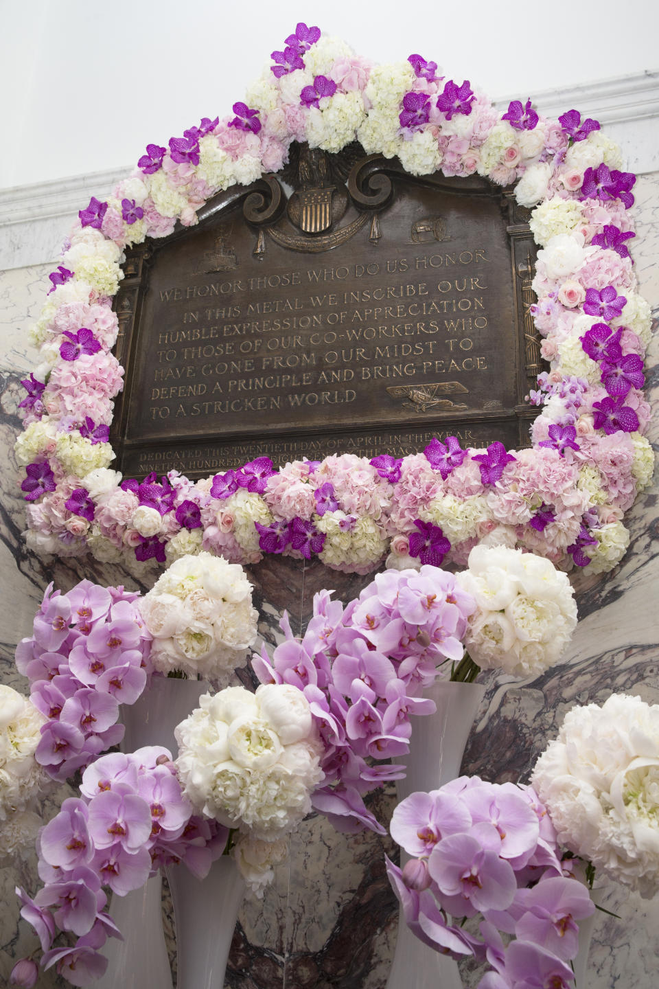 FILE -Flowers adorn the renovated Isidor and Ida Straus memorial plaque as Macy's and the Straus Historical Society celebrate its rededication during a ceremony at the Macy's Herald Square flagship store, Thursday, May 29, 2014, in New York. The plaque was first erected by employees of the store after the Titanic disaster claimed the their lives on Dec. 12, 1912. Wendy Rush. the wife of the man who was piloting the OceanGate submersible when it disappeared during a dive to the wreckage of the Titantic is a descendant of a wealthy couple who died when the ocean link sank in 1912. (AP Photo/John Minchillo, File)