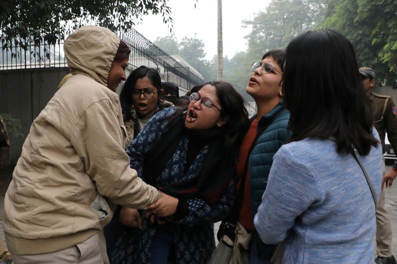 A demonstrator is being detained during a protest against a new citizenship law, in New Delhi