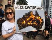 A woman holds up a sign as she takes part in a protest to call for action on climate change in Melbourne