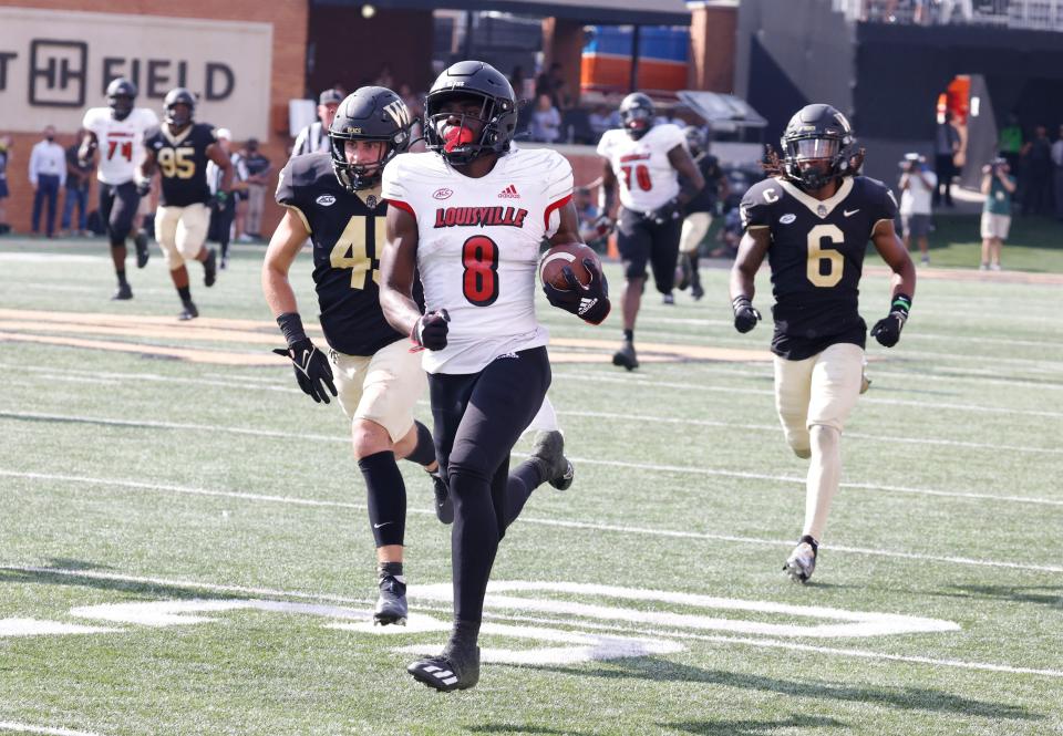 Oct 2, 2021; Winston-Salem, North Carolina, USA;  Louisville Cardinals wide receiver Tyler Harrell (8) runs past Wake Forest Demon Deacons defensive back Ja'Sir Taylor (6) and defensive back Nick Andersen (45) for a touchdown during the second half at Truist Field. Mandatory Credit: Reinhold Matay-USA TODAY Sports