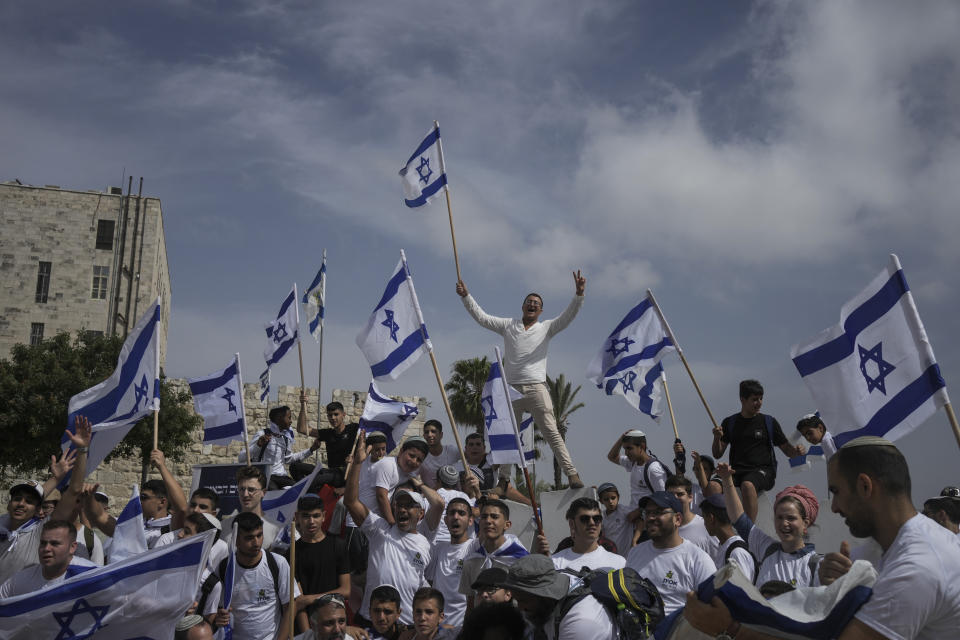 Israelis wave national flags during a march marking Jerusalem Day, just outside Jerusalem's Old City, Thursday, May 18, 2023. The parade was marking Jerusalem Day, an Israeli holiday celebrating the capture of east Jerusalem in the 1967 Mideast war. Palestinians see the march as a provocation. (AP Photo/Maya Alleruzzo)