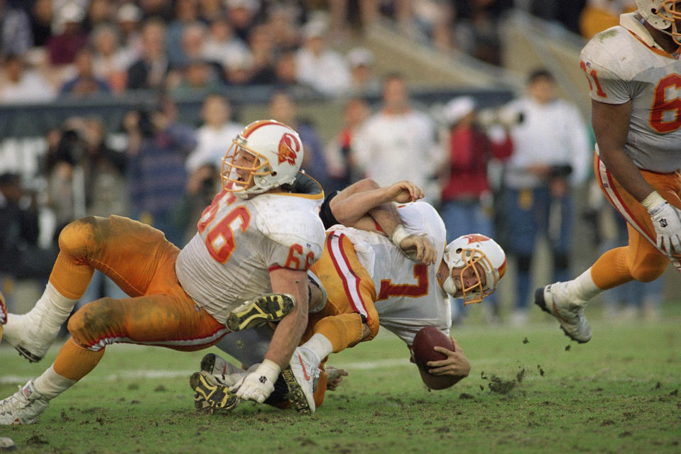 Tampa Bay Buccaneers quarterback Craig Erickson reacts as he heads for the turf while being sacked during a 1993 game. (AP Photo/Doug Pizac)