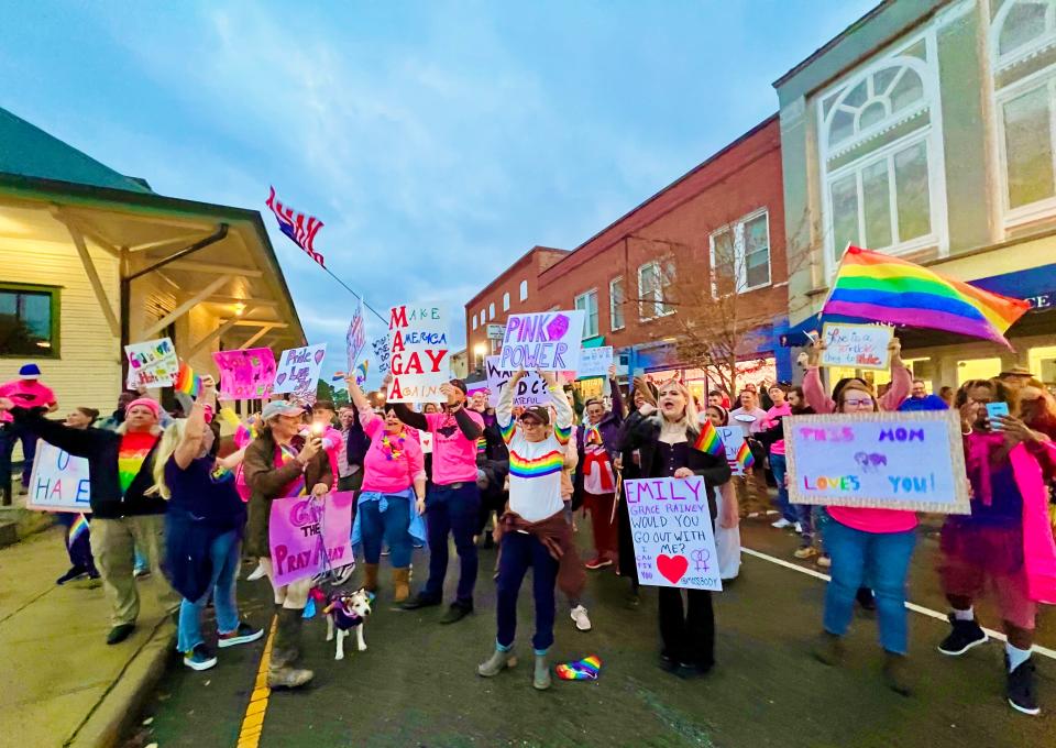 Supporters pose with signs and pride flags at Downtown Divas drag show at Sunrise Theater in Southern Pines, Dec. 3, 2022.