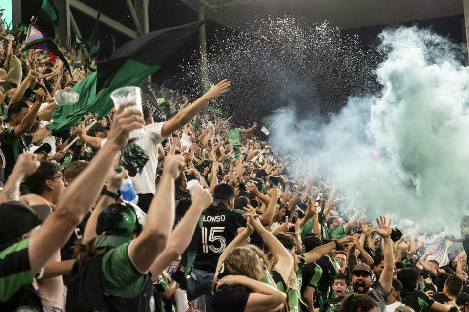 Austin FC fans celebrate the team's first goal, scored by Moussa Djitté, by throwing beer into the air during the second half of an MLS soccer match against the LA Galaxy, Sunday, Sept. 26, 2021, in Austin, Texas. Austin FC won 2-0. (AP Photo/Michael Thomas)