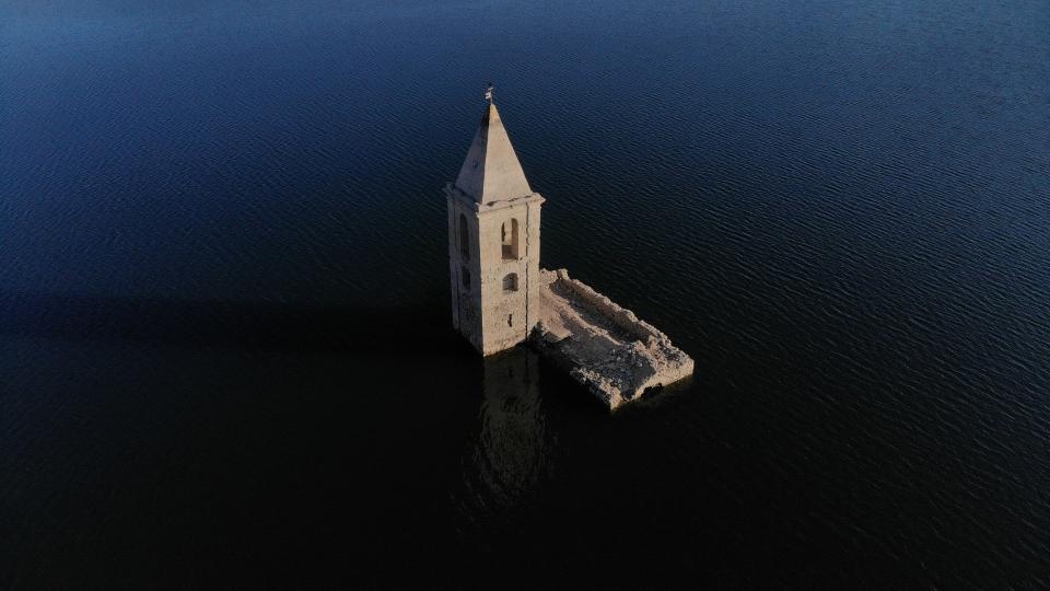 This photograph taken on Feb. 8, 2022, shows an aerial view of the partially submerged Church of Sant Roma, visible due to the low water level of the Sau reservoir, in Vilanova de Sau, Catalonia.